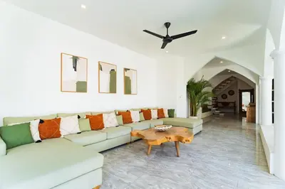 a living room with a couch and a table at Villa Nirvana Seminyak in Seminyak