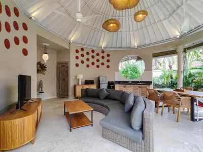 a living room with a couch and a dining room at Seminyak Square Hotel And Villas in Seminyak