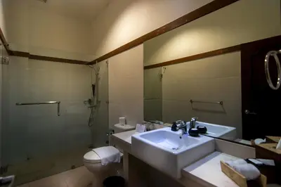a bathroom with a sink and a shower and a toilet at Seminyak Square Hotel And Villas in Seminyak