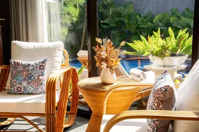 a porch with chairs and a window with plants at Villa Taj - Luxury 3-bedroom Pool Villa Near Seminyak in Kerobokan