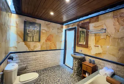 a bathroom with a toilet and a sink at Villa Mutti in Seminyak