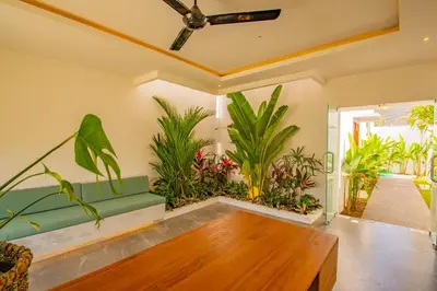 a living room with plants and a ceiling fan at Villa Yolanda - Seminyak Beach in Seminyak