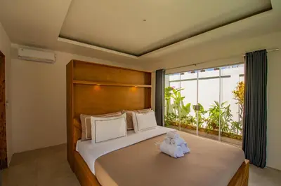 a bedroom with a bed with a stuffed animal on it at Villa Yolanda - Seminyak Beach in Seminyak