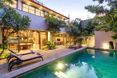 a house with a swimming pool next to a building at Family Luxury 5bd Villa Parking X Walk 2 Potato Head in Seminyak