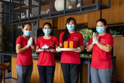 four women wearing masks and holding a box of food at Family Luxury 5bd Villa Parking X Walk 2 Potato Head in Seminyak