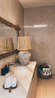 a bathroom with a sink and two lamps on a counter at Villa Hope Bali in Kerobokan