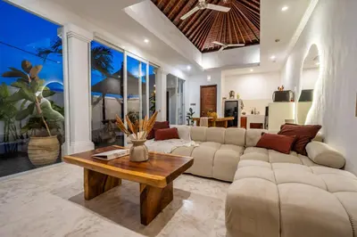 a living room with a couch and a table at Villa Ullah - 2 Bedroom with a Private Pool in Canggu