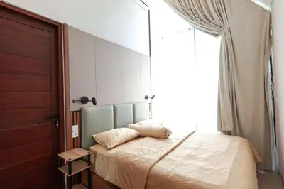 a bedroom with a bed and a large window at Yearly Rent Seminyak Huis19 Villa in Seminyak