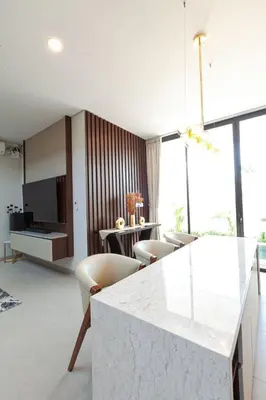 a living room with a marble counter and chairs at Yearly Rent Seminyak Huis19 Villa in Seminyak