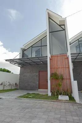 a brick house with a red door and glass at Yearly Rent Seminyak Huis19 Villa in Seminyak