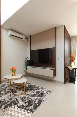 a living room with a large television and a table at Yearly Rent Seminyak Huis19 Villa in Seminyak