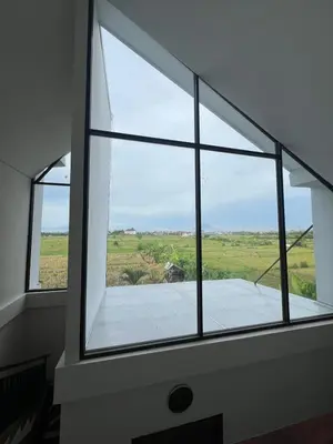 a window in a room with a view of a field at Yearly Rent Seminyak Huis19 Villa in Seminyak