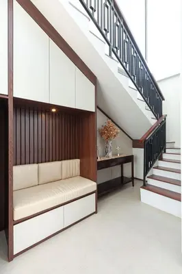 a living room with a bench under a staircase at Yearly Rent Seminyak Huis19 Villa in Seminyak