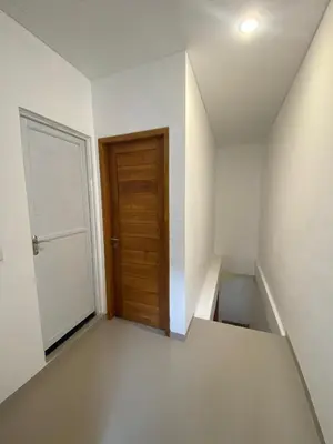 an empty room with a door and a staircase at Home Stay Room In Bali Near Sanur Beach in Sanur