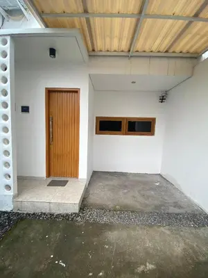 an empty room with a wooden door in a building at Home Stay Room In Bali Near Sanur Beach in Sanur