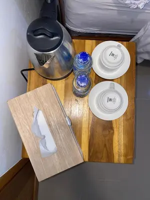 a table with two plates and a knife on it at Home Stay Room In Bali Near Sanur Beach in Sanur
