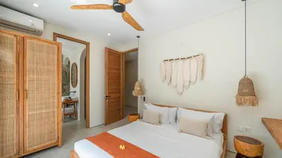 a bedroom with a bed and a ceiling fan at Villa Unna in Canggu by Elite Havens in Canggu