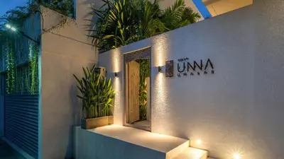 a sign on the side of a building with plants at Villa Unna in Canggu by Elite Havens in Canggu