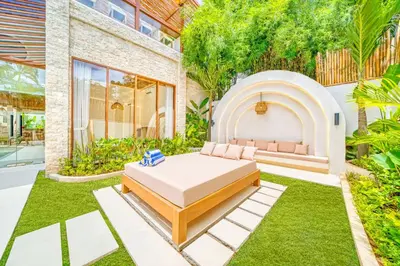 a backyard with a bed and a garden at Villa Orlando - Brand New 9BR Jacuzzi Cinema in Seminyak