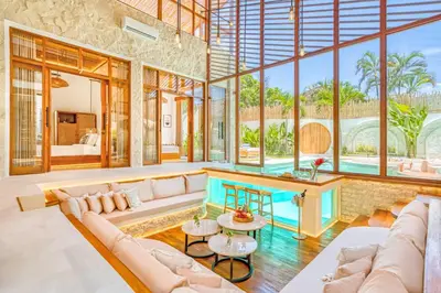 a living room with a couch and a table at Villa Orlando - Brand New 9BR Jacuzzi Cinema in Seminyak
