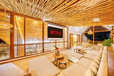 a living room with a couch and a tv at Villa Orlando - Brand New 9BR Jacuzzi Cinema in Seminyak