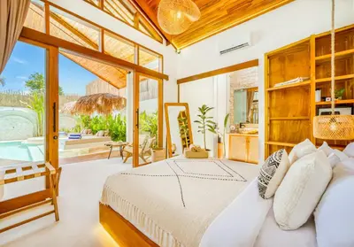 a bedroom with a bed and a large window at Villa Orlando - Brand New 9BR Jacuzzi Cinema in Seminyak