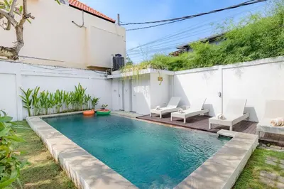a swimming pool in the backyard of a house at Villa Toto Seminyak in Seminyak