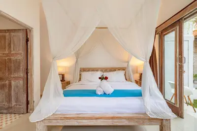 a bedroom with a bed with two stuffed animals on it at Villa Toto Seminyak in Seminyak