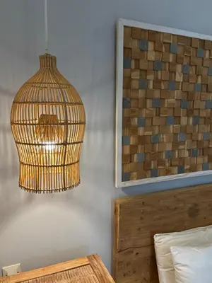 a bird cage hanging from a wall next to a bed at AMAZING 1 BR Villa Private Pool walk to beach in Seminyak