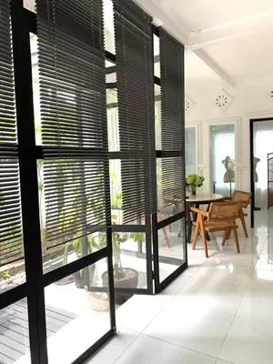 a room with black blinds on the windows at Aesthetic Villa Central Canggu With an Office in Canggu
