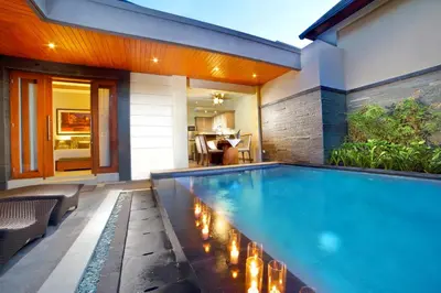 a swimming pool in the backyard of a house at The Banyumas Suite Villa Legian in Legian