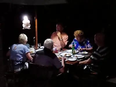 a group of people sitting around a table at Frangipani Homestay in Nusa Dua