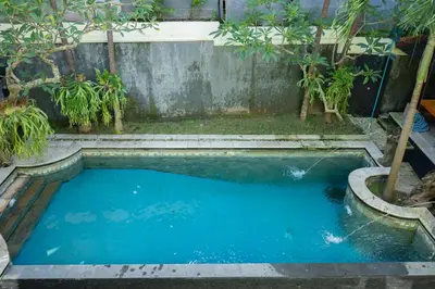 a swimming pool in a garden with trees at Villa with private pool and garden in Nusa Dua 3BR in Nusa Dua