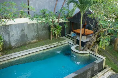 a small swimming pool with a fountain in a yard at Villa with private pool and garden in Nusa Dua 3BR in Nusa Dua