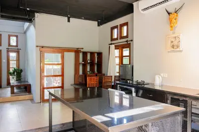 a large kitchen with a table in a room at Villa with private pool and garden in Nusa Dua 3BR in Nusa Dua