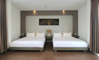two beds in a room with white sheets at Villa Maisha by REJA Villas in Nusa Dua