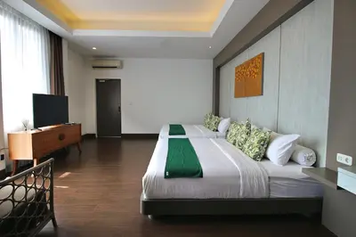 a bedroom with a large bed and a television at Villa Maisha by REJA Villas in Nusa Dua