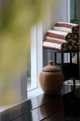 a vase sitting on a table in front of a window at Villa Maisha by REJA Villas in Nusa Dua