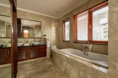 a large bathroom with a tub and two sinks at Luxury 3-Bedroom Villa With Private Pool Seminyak Village in Seminyak