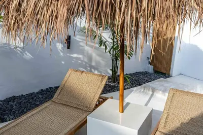 two chairs and a table with a palm tree at Casa Kokoon - NEW Bright & Quiet 2BR Mertanadi Seminyak with Private Pool and Parking in Seminyak