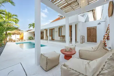 a villa with a swimming pool and a living room at Casa Kokoon - NEW Bright & Quiet 2BR Mertanadi Seminyak with Private Pool and Parking in Seminyak