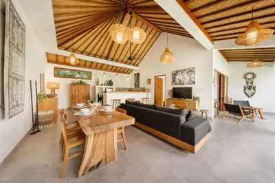 a living room with a couch and a table at Villa Kepompong Seminyak - 1BR Private Pool Villa in Seminyak