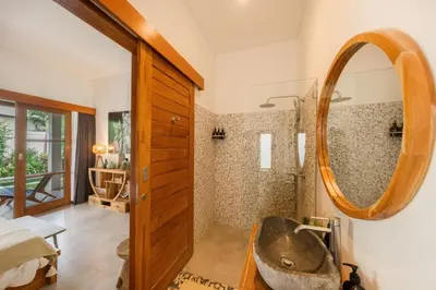 a bathroom with a sink and a mirror at Villa Kepompong Seminyak - 1BR Private Pool Villa in Seminyak
