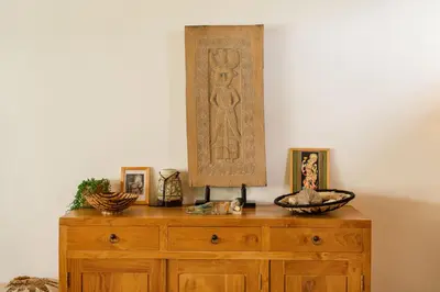 a wooden dresser with pictures on top of it at Villa Kepompong Seminyak - 1BR Private Pool Villa in Seminyak