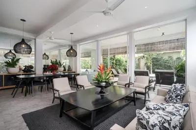 a living room with a table and chairs at Villa Stella Seminyak in Seminyak