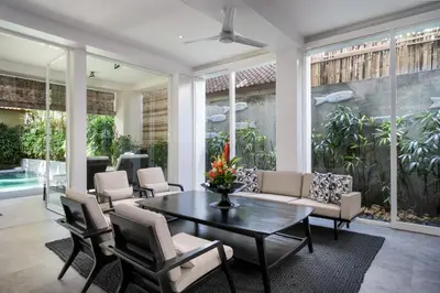 a living room with a table and chairs at Villa Stella Seminyak in Seminyak