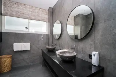 a bathroom with two sinks and a mirror at Villa Stella Seminyak in Seminyak