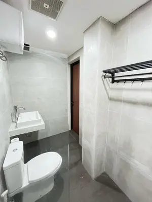 a bathroom with a white toilet and a sink at Alzeto Coliving in Legian
