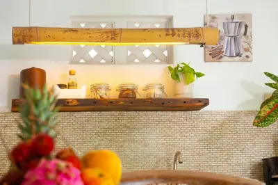 a kitchen counter with a shelf with jars and fruit at COZY 2 BR Villa Private POOL walk to the beach in Badung