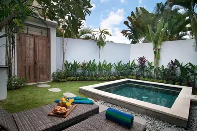 a backyard with a swimming pool and a fence at FANTASTIC 1 BR VILLA PRIVATE POOL WALK TO BEACH in Badung